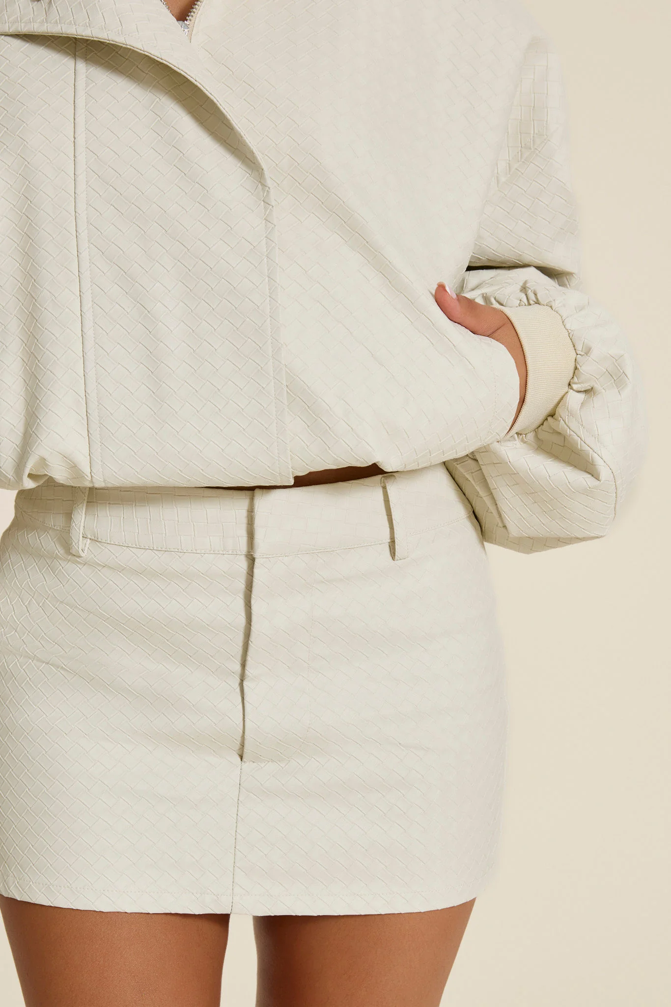 The Nyra Faux Leather Mini Skirt in Off White